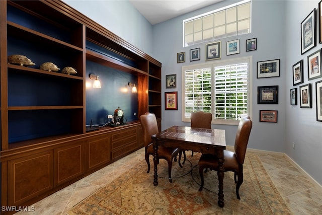 dining area featuring a high ceiling