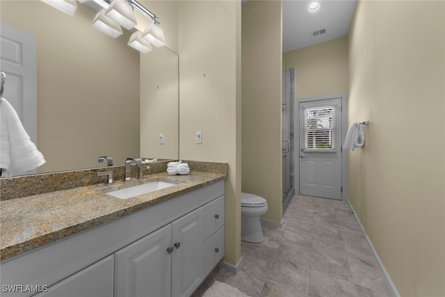 bathroom with vanity, toilet, and an enclosed shower