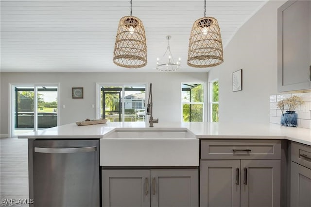 kitchen featuring a healthy amount of sunlight, dishwasher, and gray cabinets