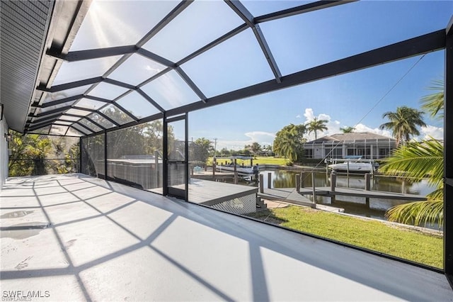 unfurnished sunroom with lofted ceiling and a water view