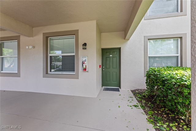 doorway to property with a patio area