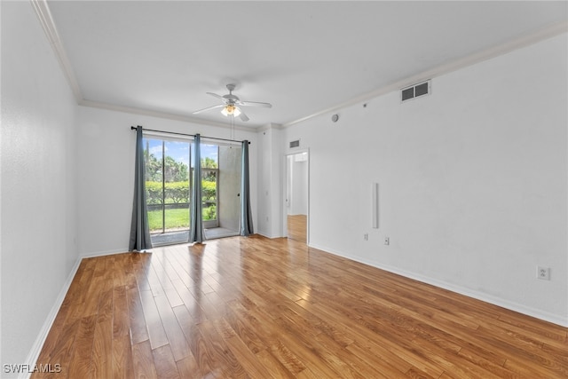 spare room featuring ceiling fan, ornamental molding, and hardwood / wood-style floors