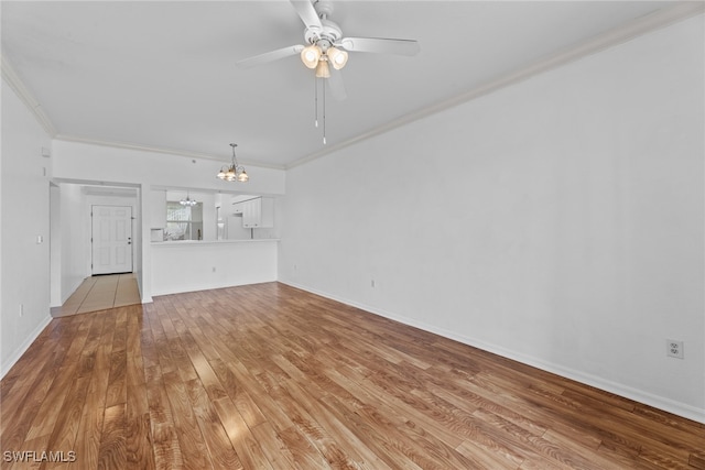 unfurnished living room with ceiling fan with notable chandelier, light wood-type flooring, and ornamental molding