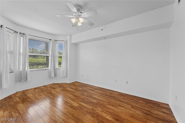 empty room featuring wood-type flooring and ceiling fan