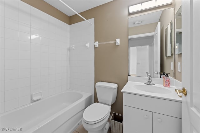 full bathroom with vanity, tiled shower / bath combo, and toilet