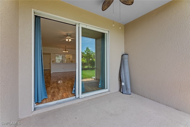 property entrance with ceiling fan