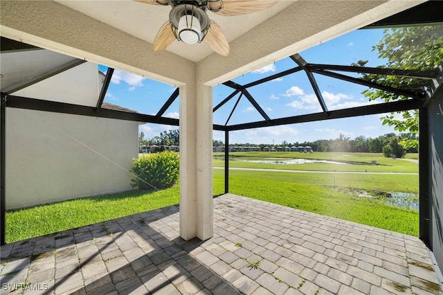 view of patio / terrace featuring a water view, a lanai, and ceiling fan