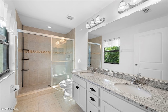 bathroom with walk in shower, vanity, toilet, and tile patterned floors