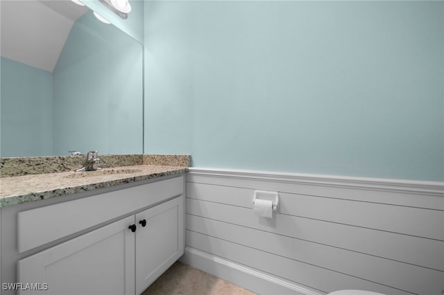 bathroom featuring vanity and vaulted ceiling