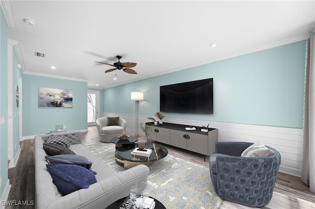 living room with ceiling fan, crown molding, and hardwood / wood-style floors