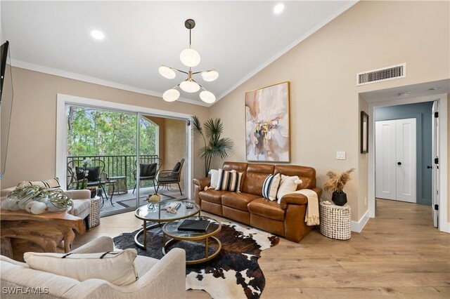 living room featuring ornamental molding, vaulted ceiling, light hardwood / wood-style floors, and a notable chandelier