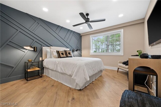 bedroom featuring ceiling fan and light hardwood / wood-style flooring