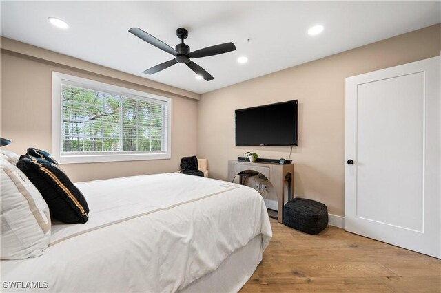 bedroom featuring light hardwood / wood-style floors and ceiling fan