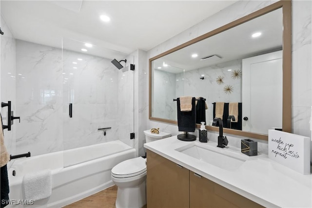 bathroom with toilet, vanity,  shower combination, wood finished floors, and recessed lighting