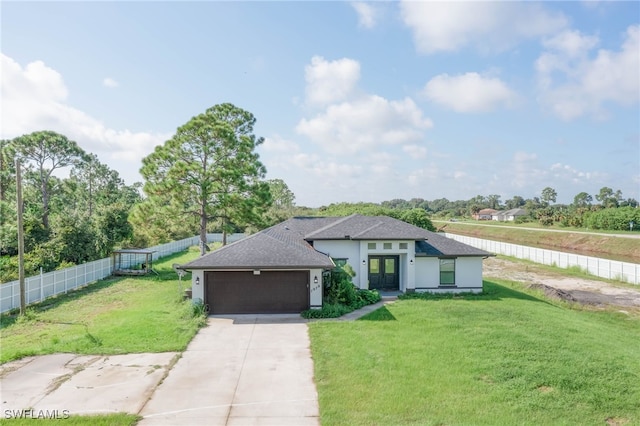 view of front of house with a front yard and a garage