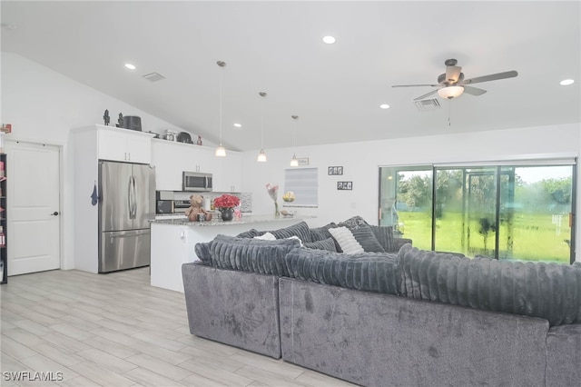 living room with ceiling fan, light hardwood / wood-style flooring, and high vaulted ceiling