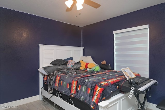 bedroom featuring ceiling fan and hardwood / wood-style flooring