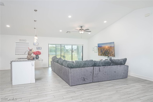 living room featuring light hardwood / wood-style floors, ceiling fan, and high vaulted ceiling