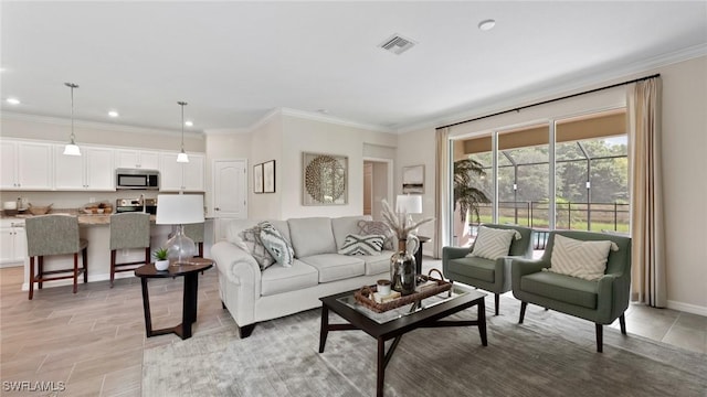 living room with recessed lighting, ornamental molding, baseboards, and visible vents