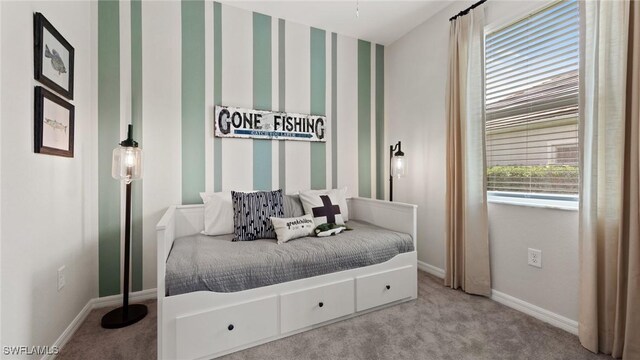 carpeted bedroom with wallpapered walls and baseboards