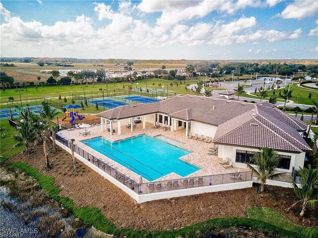 pool with fence and a patio