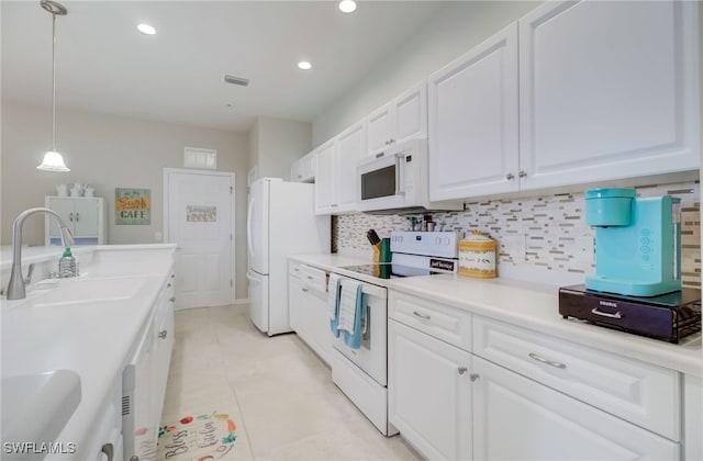 11741 Pasetto Ln Unit 404, Fort Myers, FL 33908 - kitchen with white appliances, a sink, white cabinetry, backsplash, and recessed lighting