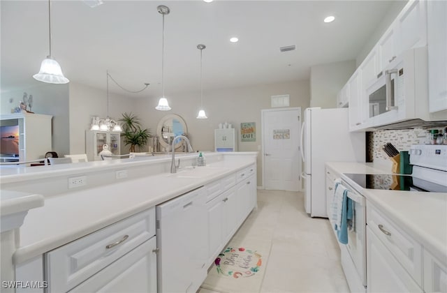 kitchen featuring pendant lighting, white cabinets, white appliances, and sink