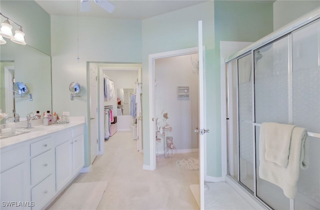 bathroom featuring ceiling fan, vanity, and a shower with shower door