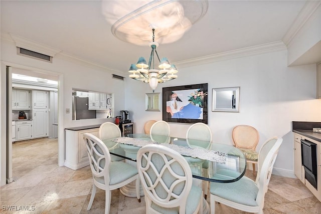 dining room with crown molding and a notable chandelier