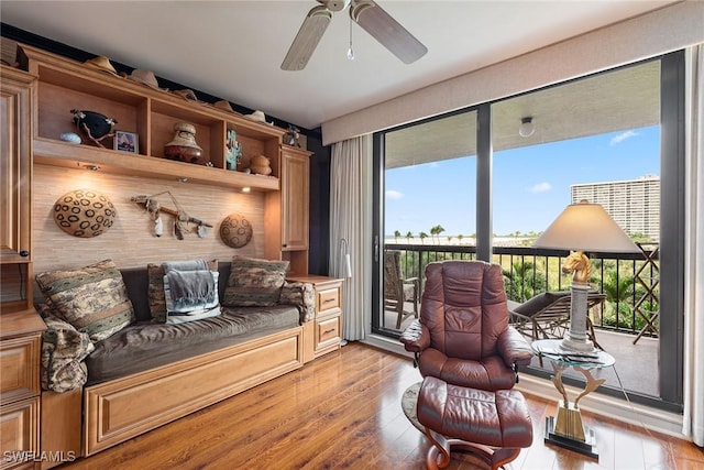 sitting room featuring ceiling fan and light wood-type flooring