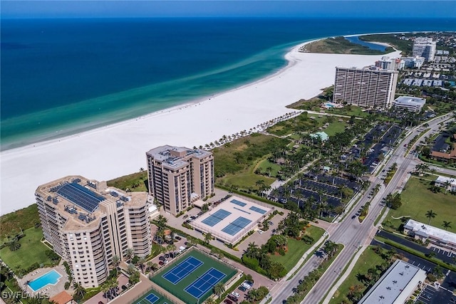 bird's eye view featuring a water view and a beach view