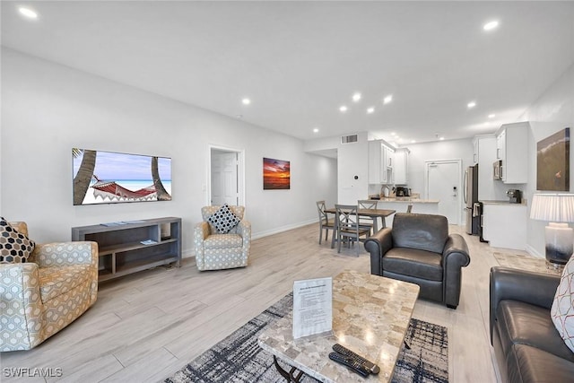 living room with light hardwood / wood-style flooring