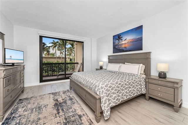 bedroom featuring access to exterior and light hardwood / wood-style floors