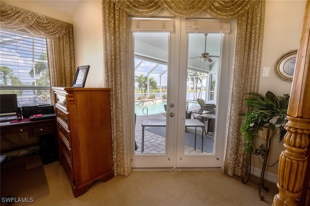 entryway featuring french doors, light colored carpet, and ceiling fan