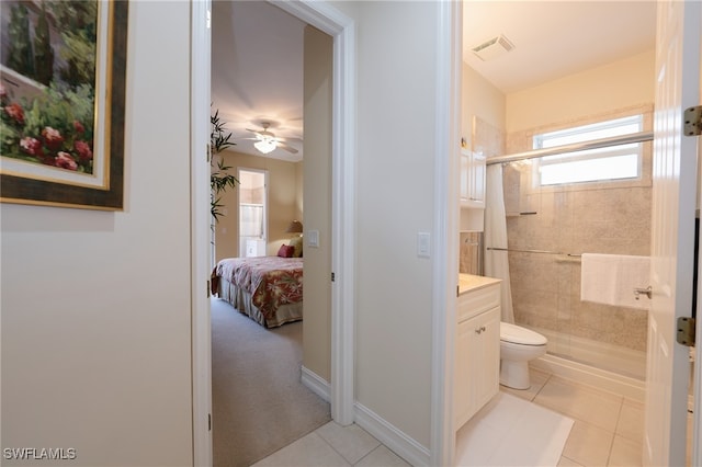 bathroom featuring a tile shower, tile patterned floors, vanity, and toilet