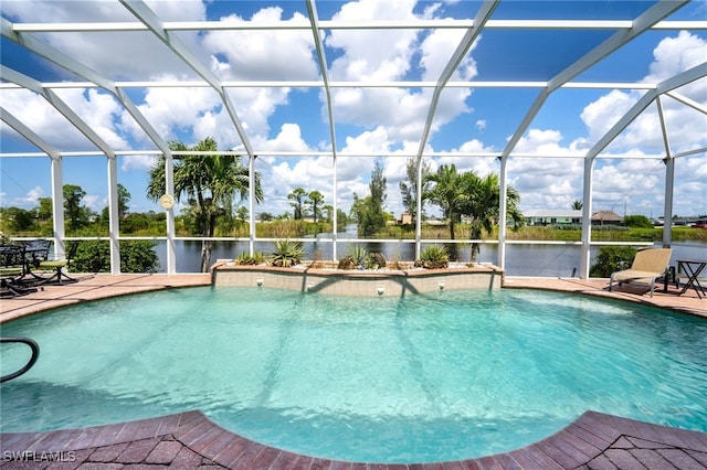 view of pool featuring a water view, a lanai, and a patio area