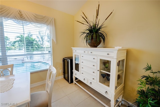 sitting room featuring light tile patterned flooring and lofted ceiling