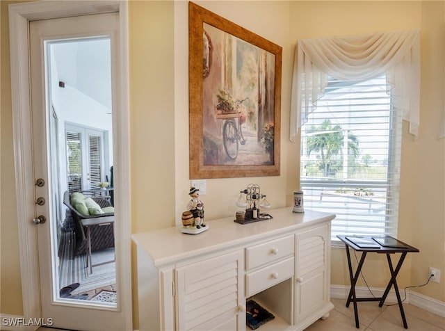 interior space featuring light tile patterned floors and plenty of natural light