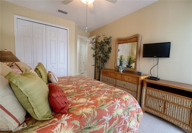 carpeted bedroom featuring ceiling fan and a closet