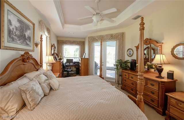 bedroom featuring ceiling fan, access to outside, a raised ceiling, ornamental molding, and light colored carpet