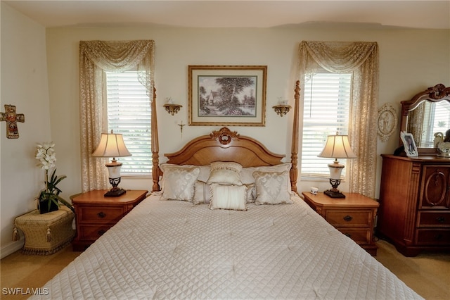 carpeted bedroom with multiple windows