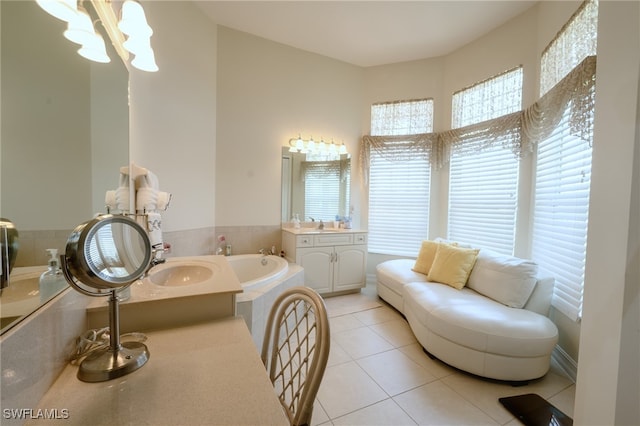 bathroom with vanity, a tub to relax in, a chandelier, and tile patterned floors