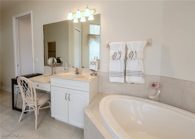 bathroom with tile patterned flooring, vanity, and a relaxing tiled tub