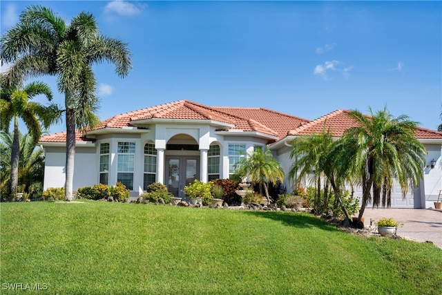 mediterranean / spanish-style house with a garage and a front yard