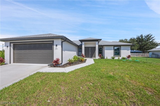 prairie-style home with a garage and a front lawn