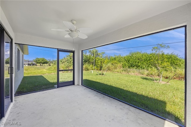 unfurnished sunroom with plenty of natural light and ceiling fan