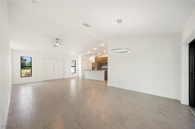 2611 NE 22nd Ave, Cape Coral, FL 33909 - unfurnished living room featuring a ceiling fan, baseboards, lofted ceiling, and recessed lighting