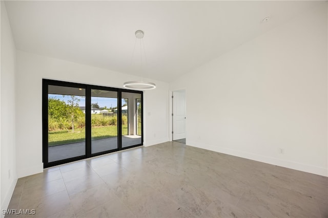 empty room featuring lofted ceiling