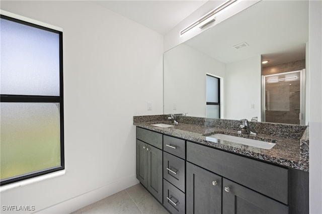 bathroom with vanity, tile patterned flooring, and an enclosed shower