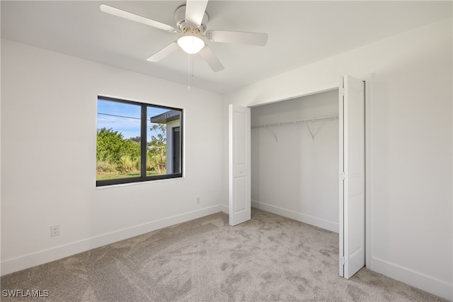 unfurnished bedroom featuring a closet, ceiling fan, and light colored carpet